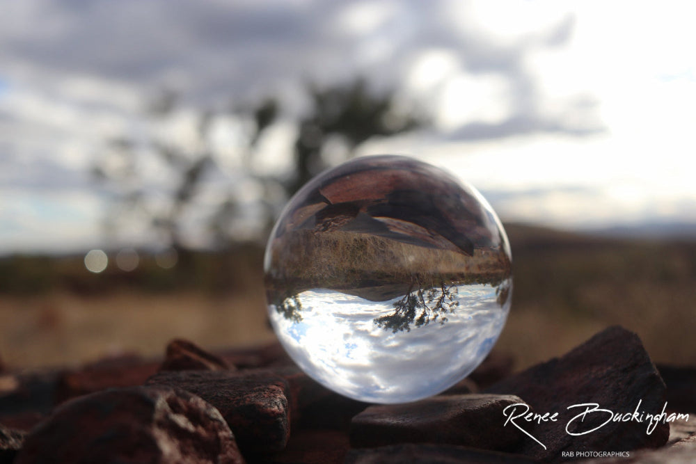 Crystal ball with landscape reflection on a natural background